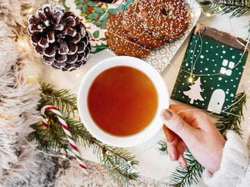 Cozy Nepali black tea in a cup with cookies, styled as a holiday gift tea moment