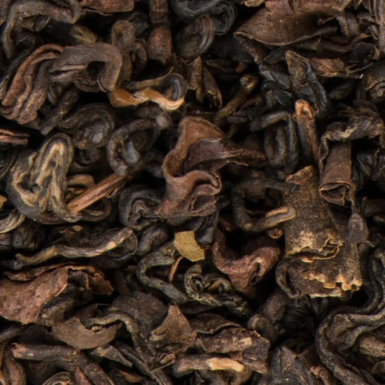 Close-up of premium Black Yeti Oolong loose-leaf tea from Nepal, highlighting the textured, dark leaves with notes of apricot and honey.