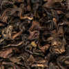 Close-up of premium Black Yeti Oolong loose-leaf tea from Nepal, highlighting the textured, dark leaves with notes of apricot and honey.