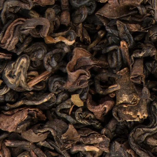 Close-up of premium Black Yeti Oolong loose-leaf tea from Nepal, highlighting the textured, dark leaves with notes of apricot and honey.