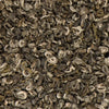 Dry loose-leaf Half Moon Pearl green tea from Nepal, featuring hand-rolled silvery buds and dark green leaves.