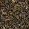 Close-up of dried Makalu green tea leaves mixed with real peppermint and spearmint botanicals