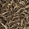 Detailed view of Manaslu Spring Tippy first flush tea leaves featuring soft downy buds and spring-green edges.