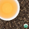 Brewed cup of Rara Willow Organic White Tea on loose-leaf tea with USDA Organic badge (Nepal)