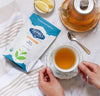Rara Willow Organic White Tea from Nepal—Nepali Tea Traders pouch with a brewed teacup, glass teapot, and lemon slices.