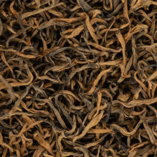 Macro shot of award-winning Sagarmatha Gold black tea leaves from Nepal, featuring signature golden tips and twisted texture.