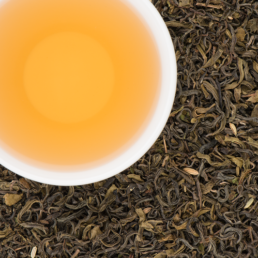 Brewed Makalu Mint tea in a glass cup, golden liquor